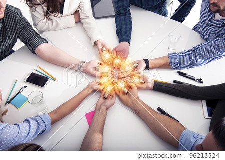 Teamwork and brainstorming concept with businessmen that share an idea with a lamp. Concept of startup 96213524