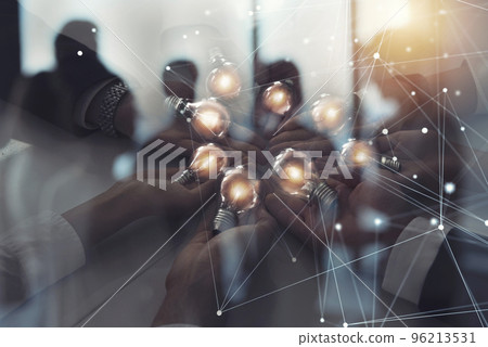 Teamwork and brainstorming concept with businessmen that share an idea with a lamp with network lines. Concept of startup. Double exposure Teamwork and brainstorming concept with businessmen that share an idea with a lamp with network lines. Concept of startup. Double exposure 96213531