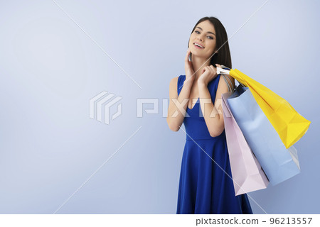 Happy woman with shopping bags in hand 96213557