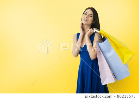 Happy woman with shopping bags in hand 96213573