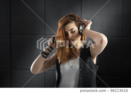 Dancing girl listens to music with headset Dancing girl listens to music with headset 96213616