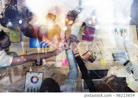 Business people putting their hands together. Concept of integration, teamwork and partnership. Double exposure 96213654