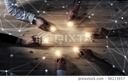 Teamwork and brainstorming concept with businessmen that share an idea with a lamp. Concept of startup 96213657