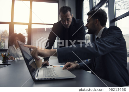 Business people work together in office with a laptop. Concept of teamwork and partnership 96213668