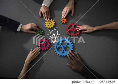Business team connect pieces of gears to build a new creative idea. Teamwork, partnership and integration concept Business team connect pieces of gears to build a new creative idea. Teamwork, partnership and integration concept 96213686