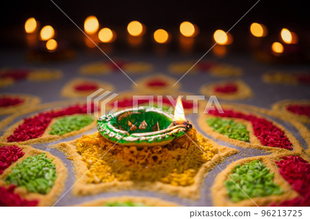 Happy Diwali - Diya lamps lit during diwali celebration Happy Diwali - Diya lamps lit during diwali celebration 96213725