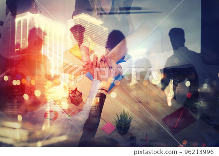 Handshaking business person in office. concept of teamwork and partnership. double exposure with light effects Handshaking business person in office. concept of teamwork and partnership. double exposure with light effects 96213996
