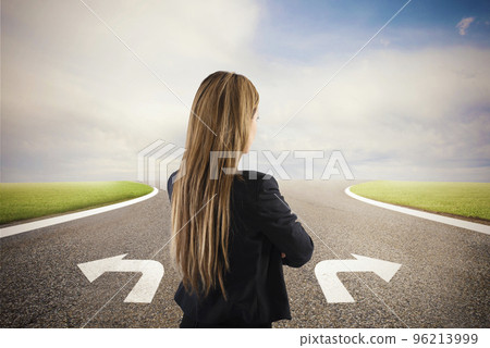 Businesswoman at a crossroads. She chooses the correct way. Concept of decision in business Businesswoman at a crossroads. She chooses the correct way. Concept of decision in business 96213999
