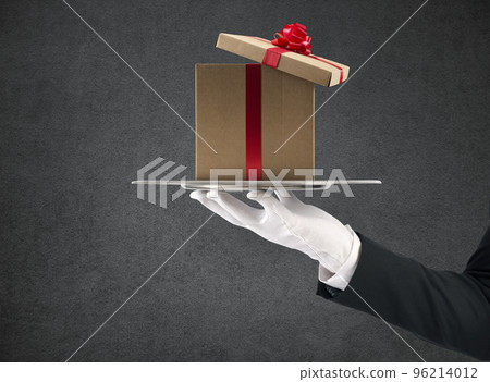 Waiter holds a Christmas present in a tray 96214012