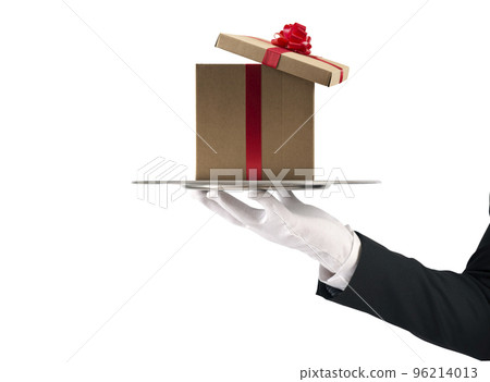 Waiter holds a Christmas present in a tray. Isolated on white background Waiter holds a Christmas present in a tray. Isolated on white background 96214013