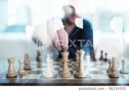 Business tactic with chess game and businessmen that work together in office. Concept of teamwork, partnership and strategy. double exposure 96214503