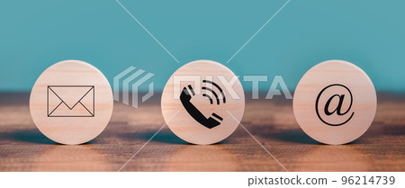 Customer Contact Us Service with Mail, Email, Telephone icons on the circle wooden  put on the desk. 96214739