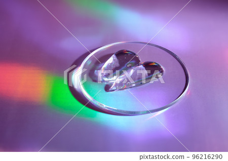 Smear of gel cosmetics product in petri dish on holographic background with iridescent highlights Smear of gel cosmetics product in petri dish on holographic background with iridescent highlights 96216290