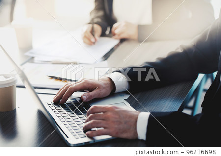 Businessman works with a laptop in office 96216698