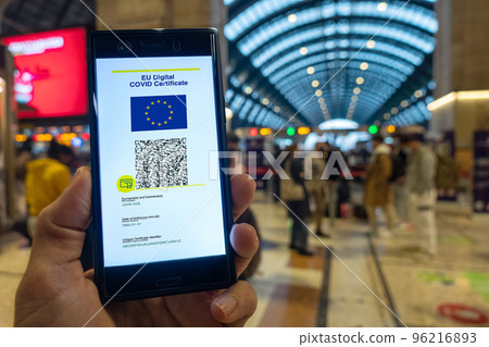 Woman showing on smartphone EU Digital Covid Certificate. Woman showing on smartphone EU Digital Covid Certificate. 96216893