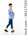 Asian boy 10 years old in casual blazer walking smart and happily looking at camera on isolated white background 96217260