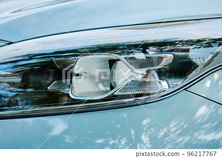 Moder car headlight with led lamp outdoors. Part of new car, turquoise color 96217767