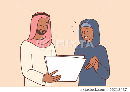Smiling Arabic businesspeople discuss paperwork Smiling Arabic businesspeople discuss paperwork 96218487