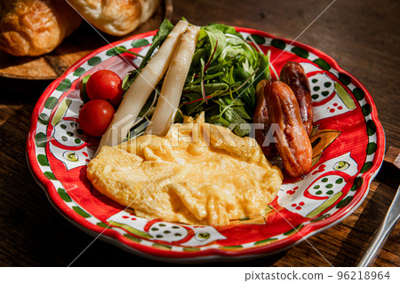 Breakfast of simmering omelette, sausages and white asparagus Breakfast of simmering omelette, sausages and white asparagus 96218964