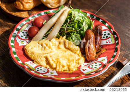 Breakfast of simmering omelette, sausages and white asparagus Breakfast of simmering omelette, sausages and white asparagus 96218965
