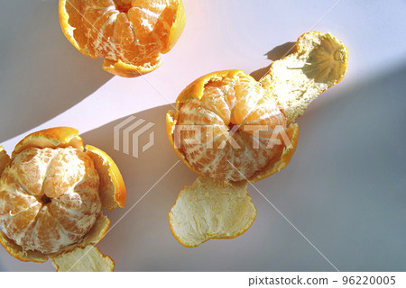Tangerines on a white table in the sun rays. Tangerines on a white table in the sun rays. 96220005