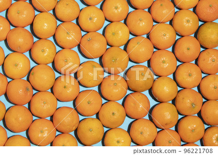 Juicy and healthy mandarins on a blue background 96221708