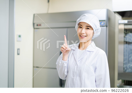 Young female cook (pointing pose) Young female cook (pointing pose) 96222026