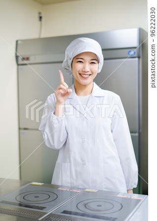 Young female cook (pointing pose) Young female cook (pointing pose) 96222030