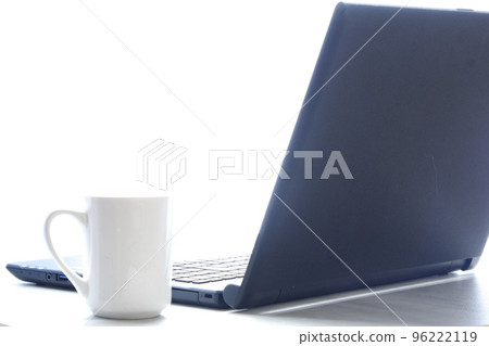 Desk work on a laptop (black) while drinking coffee 96222119