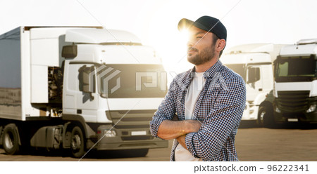 Truck driver in front of trucks 96222341