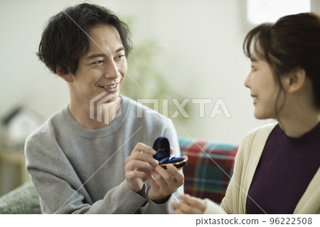 Young man proposing in the living room 96222508