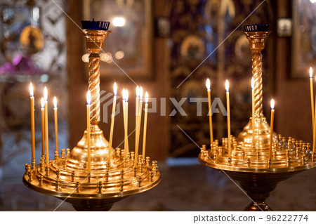 yellow burning candles in an orthodox church with a beautiful interior yellow burning candles in an orthodox church with a beautiful interior 96222774