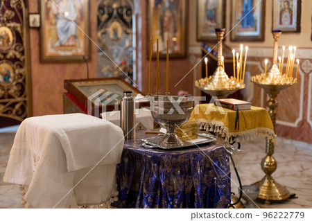 metal font for christening in the church with candles 96222779