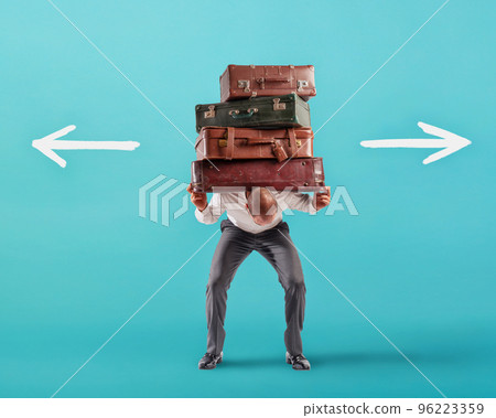 Man with a lot of luggages is confused about the right destination 96223359