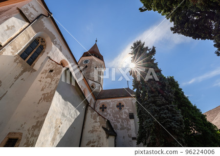 Sun shines through old fir, Prejmer fortified church most popular tourist attraction in Transylvania 96224006