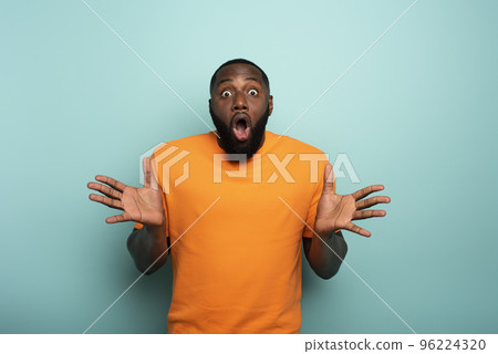 Amazed and shocked expression of a boy over cyan background Amazed and shocked expression of a boy over cyan background 96224320