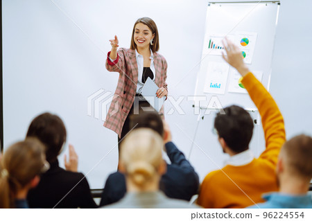 Young woman coach speaker giving flipchart presentation, speaker leading training 96224554