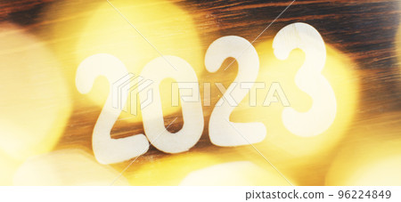 wooden number 2023 on christmas beautifull shiny gold background. sparkle festive blurred bokeh wooden number 2023 on christmas beautifull shiny gold background. sparkle festive blurred bokeh 96224849