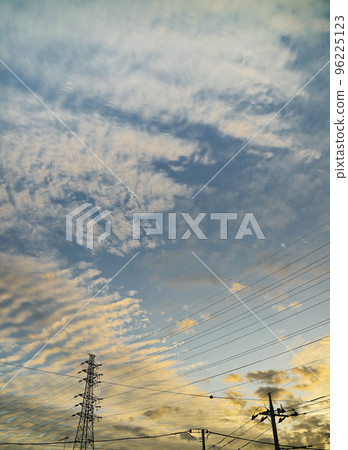 The silhouette of a steel tower in the autumn sky at dusk with sardine clouds The silhouette of a steel tower in the autumn sky at dusk with sardine clouds 96225123