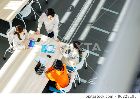 Male and female college students having a meeting in a classroom 96225193