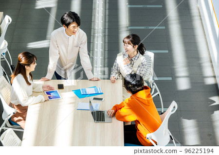 Male and female college students having a meeting in a classroom 96225194