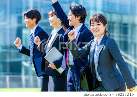 Businesswoman and businessman lined up under blue sky Businesswoman and businessman lined up under blue sky 96225210