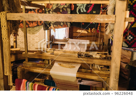 A loom in an old wooden house, made in the 19th century 96226048