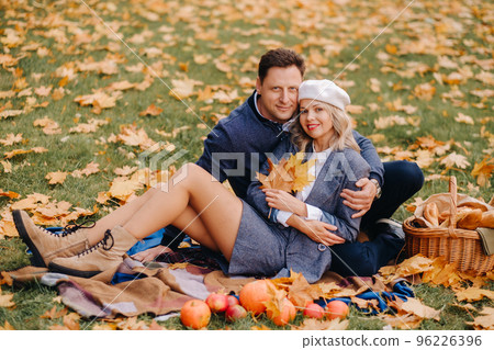 Happy couple enjoying golden autumn spring season in the park Happy couple enjoying golden autumn spring season in the park 96226396