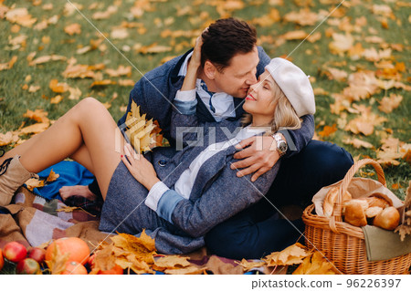 Happy couple enjoying golden autumn spring season in the park Happy couple enjoying golden autumn spring season in the park 96226397