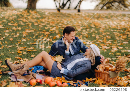 Happy couple enjoying golden autumn spring season in the park Happy couple enjoying golden autumn spring season in the park 96226398