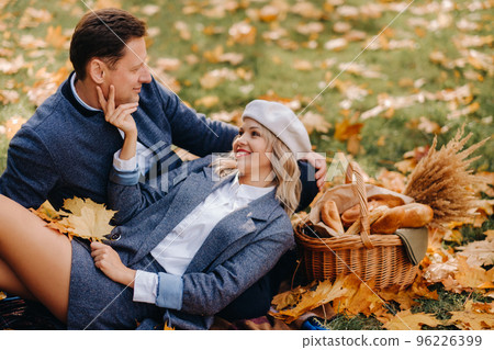 Happy couple enjoying golden autumn spring season in the park Happy couple enjoying golden autumn spring season in the park 96226399