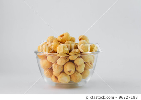 Freeze dried longan in glass bowl on white background. Freeze-drying is a processing that preserves the nutritional value of food. 96227188