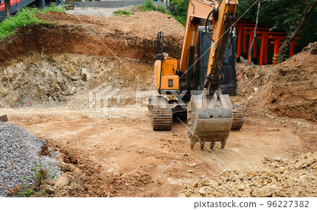 Front view of a crawler excavator at a construction site. Digging the pit foundation. Front view of a crawler excavator at a construction site. Digging the pit foundation. 96227382