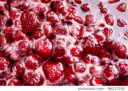 Cooking strawberry jam close up. Cooking strawberry jam close up. 96227592